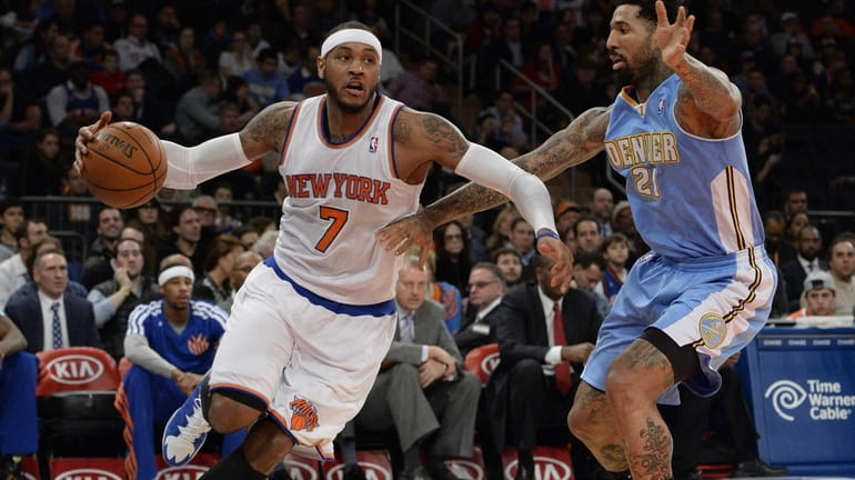 Knicks forward Carmelo Anthony drives the ball past Denver Nuggets...