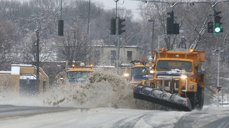 Plows clear the snow on Route 25 in Coram on...