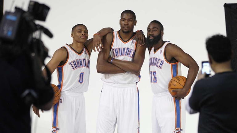 Oklahoma City Thuder's Russell Westbrook (0), Kevin Durant, center, and...