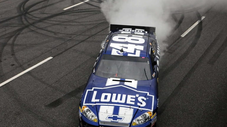 Jimmie Johnson does a burnout after winning the NASCAR Sprint...