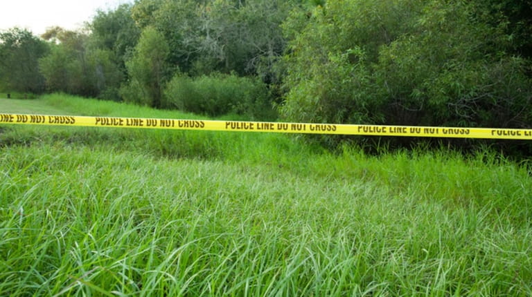 Police tape restricts access to Myakkahatchee Creek Environmental Park in North...