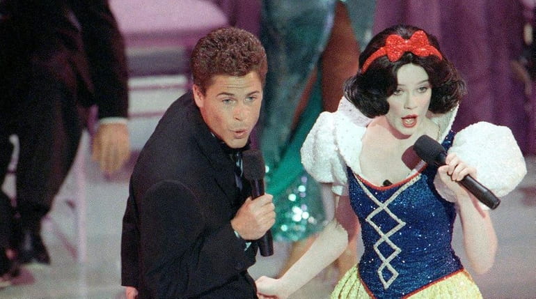 Actor Rob Lowe croons a tune to Snow White during...
