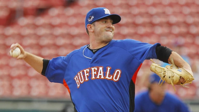 The Bisons' Matt Harvey throws to a Mud Hens batter...