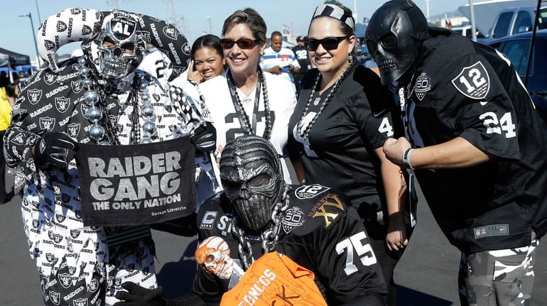 Oakland Raiders fans tailgate before an NFL football game between...