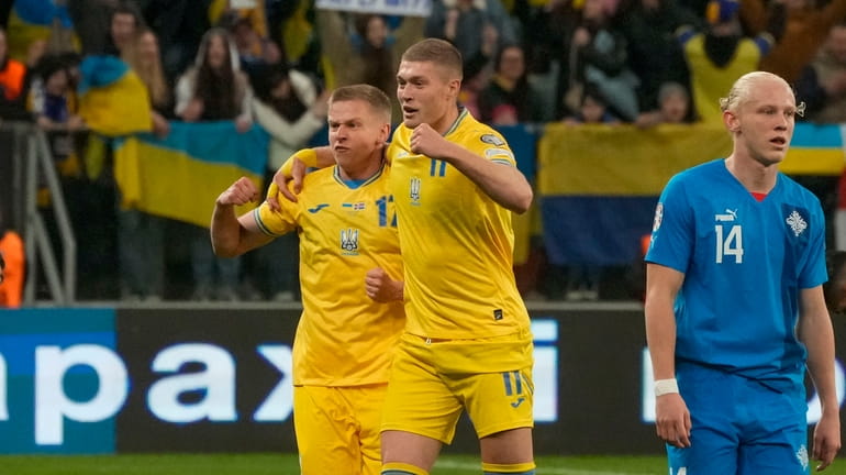 Ukraine's Oleksandr Zinchenko, left, and Ukraine's Artem Dovbyk celebrate at...