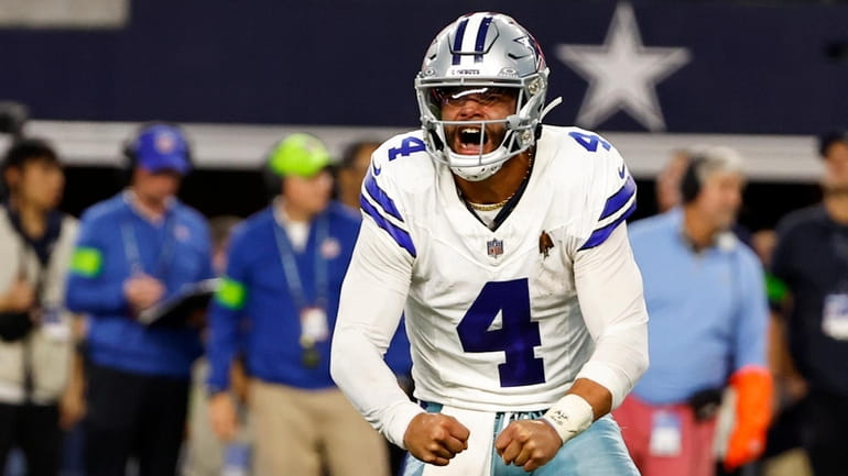 Dallas Cowboys quarterback Dak Prescott (4) celebrates after throwing a...