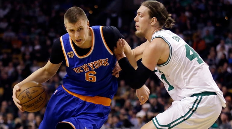 New York Knicks forward Kristaps Porzingis drives against Boston Celtics...