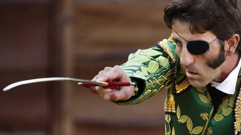 Spanish bullfighter Juan Jose Padilla aims his sword during a...