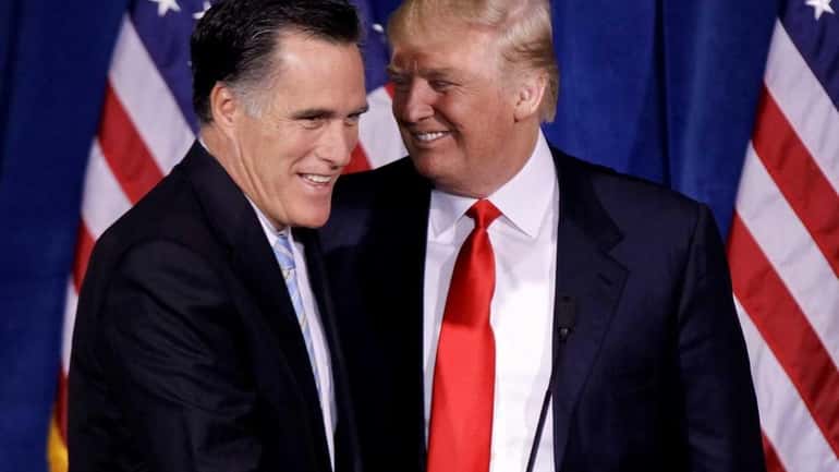 Businessman Donald Trump greets Republican presidential candidateMitt Romney during a...