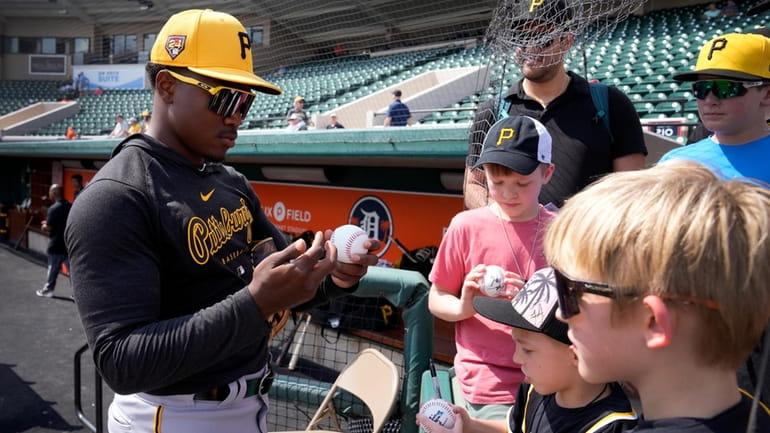 Pittsburgh Pirates second baseman Termarr Johnson signs autographs before a...