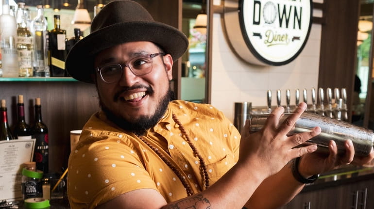 Jonathan Gonzalez behind the bar of Whiskey Down Diner in...