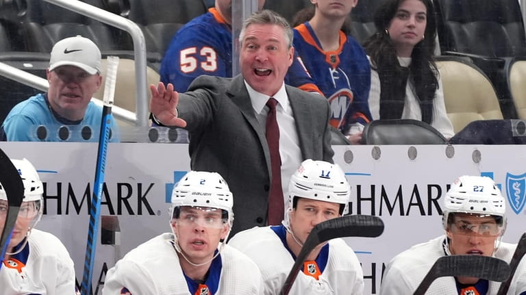 New York Islanders head coach Patrick Roy gives instructions from...