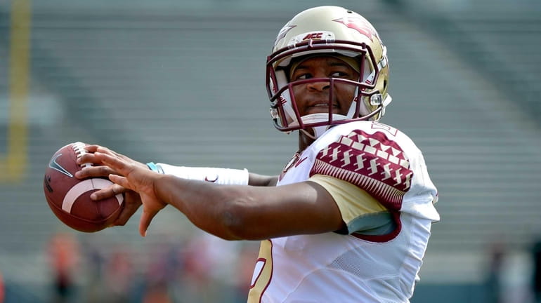 Jameis Winston of the Florida State Seminoles warms up before...