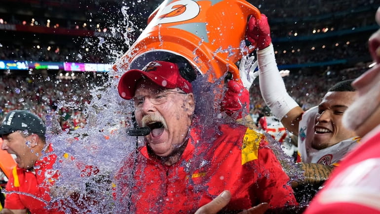 Kansas City head coach Andy Reid is dunked after their...