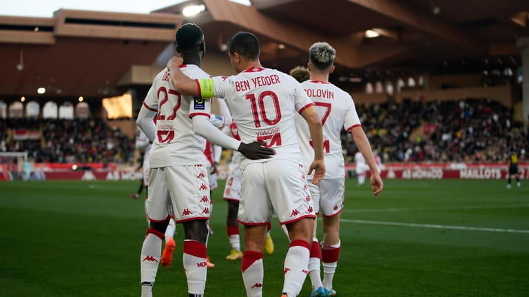 Monaco's Wissam Ben Yedder, center, is congratulated after scoring his...