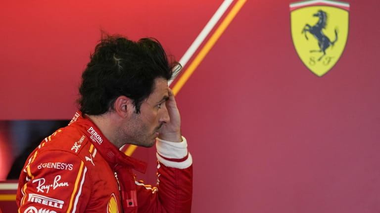 Ferrari driver Carlos Sainz of Spain reacts following the first...