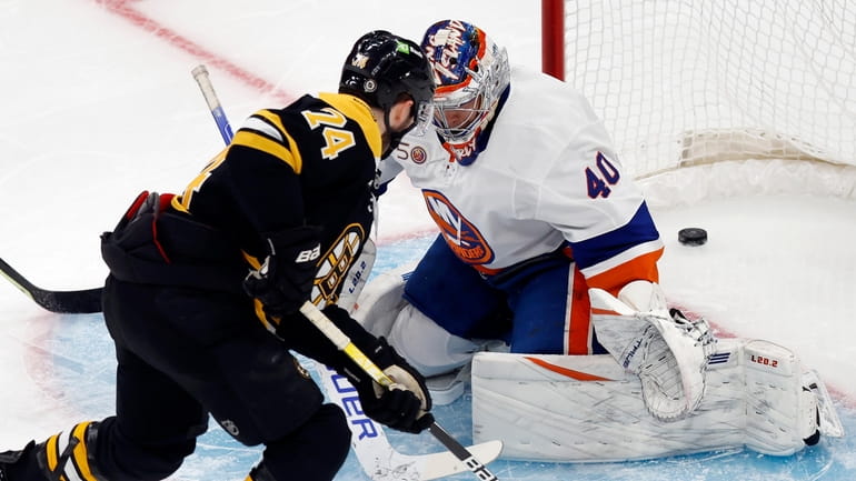 The Bruins' Jake DeBrusk scores against Islanders goalie Semyon Varlamov during the...