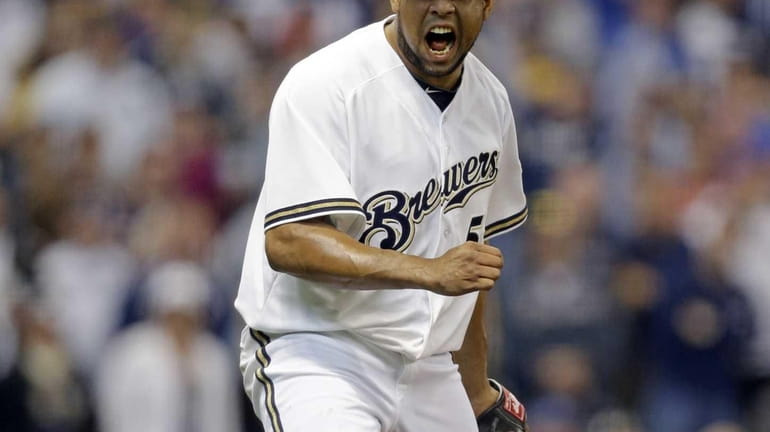 Milwaukee Brewers pitcher Francisco Rodriguez reacts after getting the last...