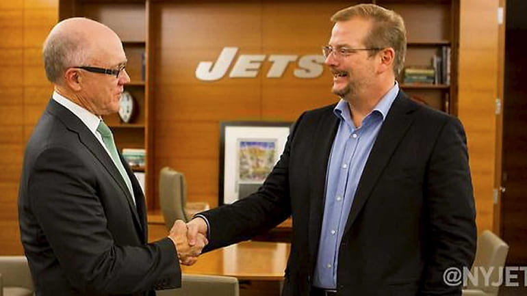 New York Jets owner Woody Johnson poses with Mike Maccagnan,...