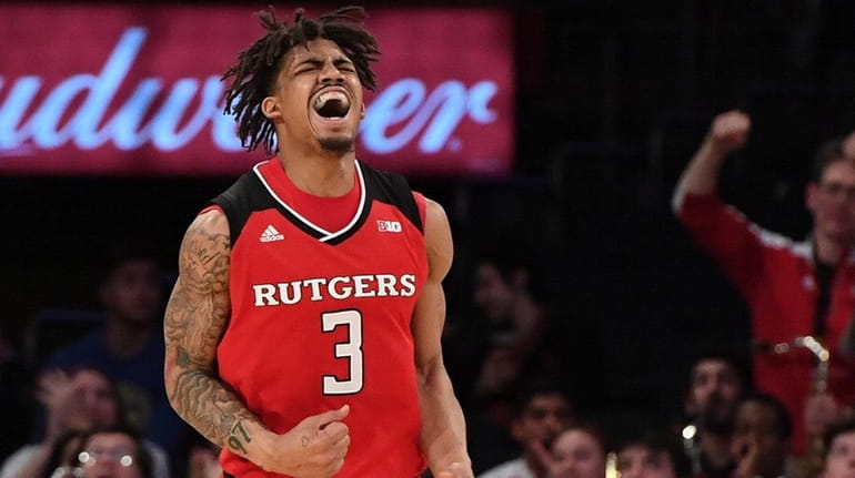 Rutgers guard Corey Sanders reacts after sinking a three-point basket...