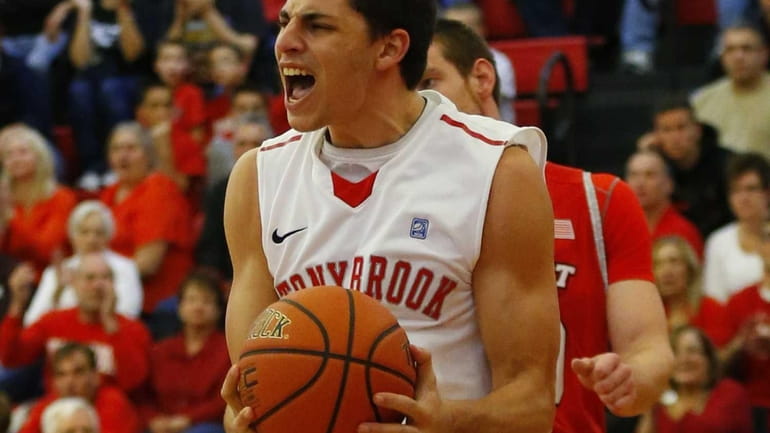 Eric McAlister of the Stony Brook Seawolves celebrates after dunking...