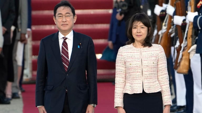 Japan's Prime Minister Fumio Kishida, left, and his wife Yuko...