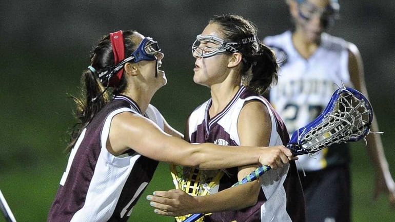 Bay Shore's Kaitlyn Arnold, left, and Cynthia DelCore, right, celebrate...