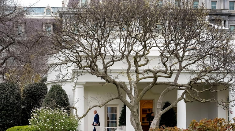 President Joe Biden walks out of the Oval Office to...