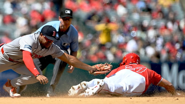 Boston Red Sox second baseman Enmanuel Valdez, left, misses on...