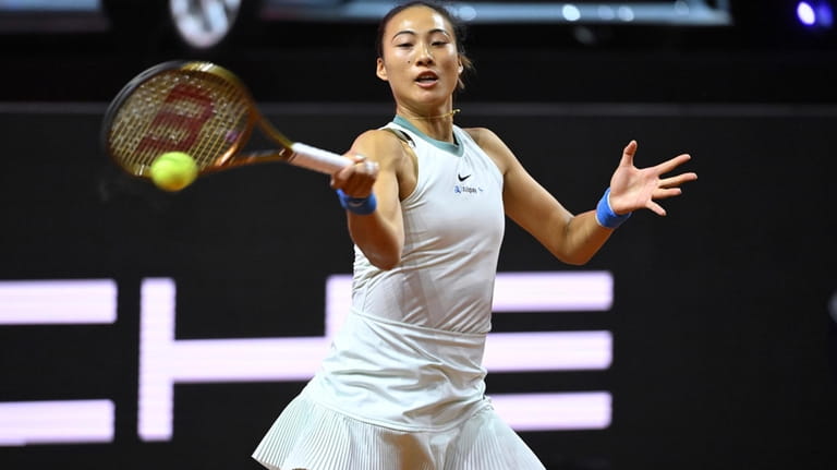 China's Qinwen Zheng returns the ball to Romania's Sorana Cristea...
