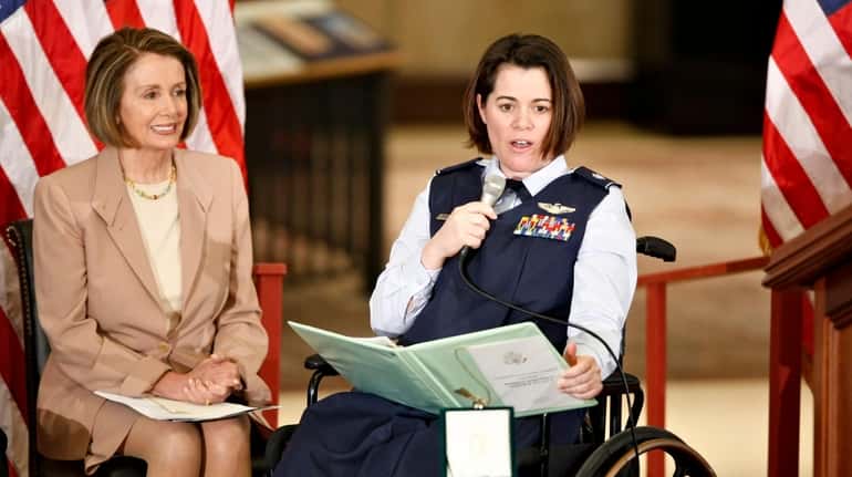 Air Force Lt. Col. Nicole Malachowski, right, is joined by...