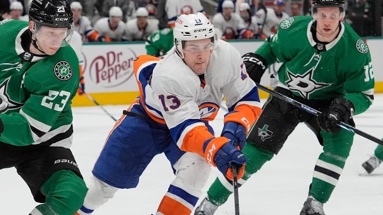 Islanders center Mathew Barzal (13) skates for the puck against...