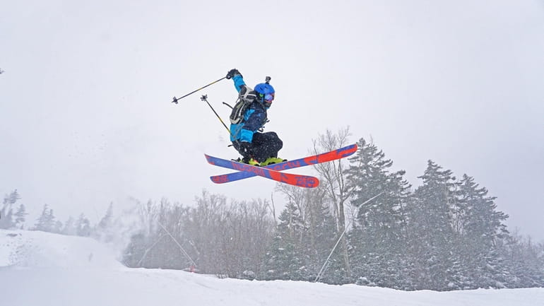 A skier takes a big jump while testing the slopes...