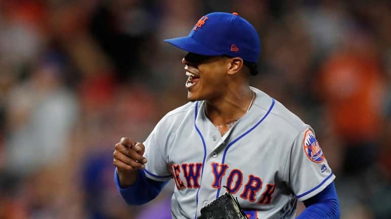 Mets starting pitcher Marcus Stroman reacts after catcher Wilson Ramos...