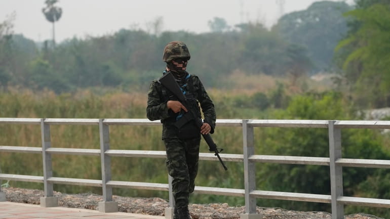 Thai military soldier keeps guard along the Moei river on...