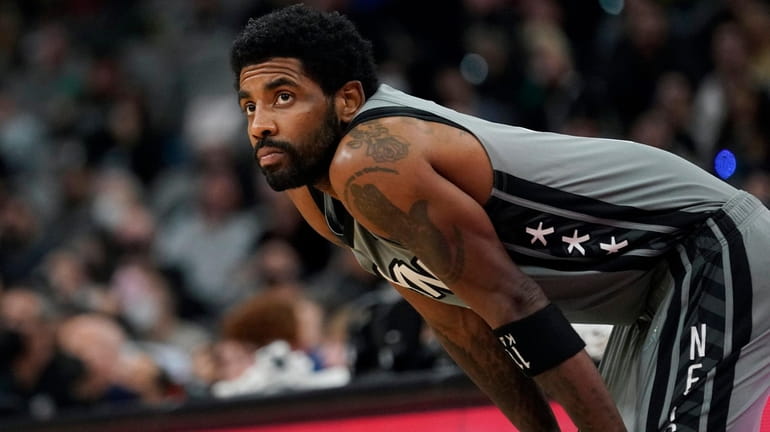 Nets guard Kyrie Irving waits for play to resume during...