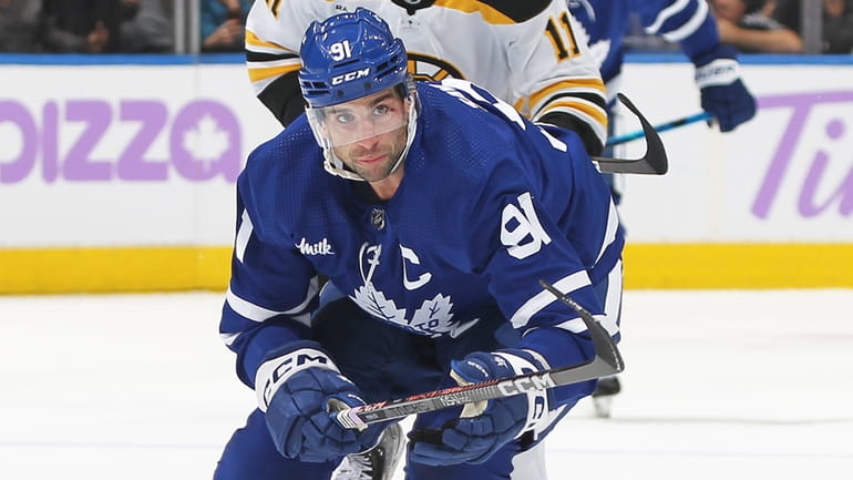 John Tavares #91 of the Toronto Maple Leafs skates against...