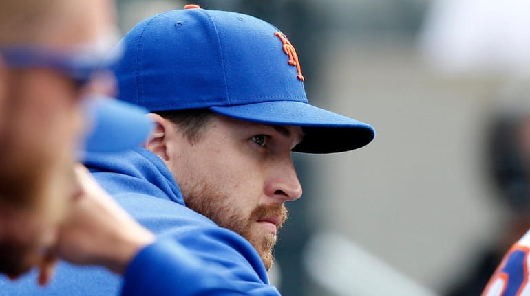 Mets pitcher Jacob deGrom looks on from the dugout during...