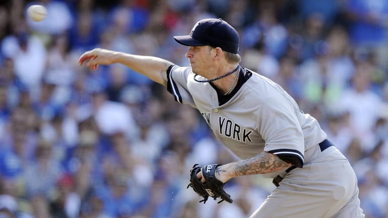 New York Yankees starting pitcher A.J. Burnett throws to the...