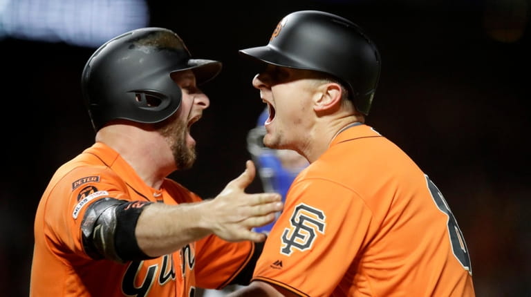 San Francisco Giants' Alex Dickerson, right, celebrates with Stephen Vogt...