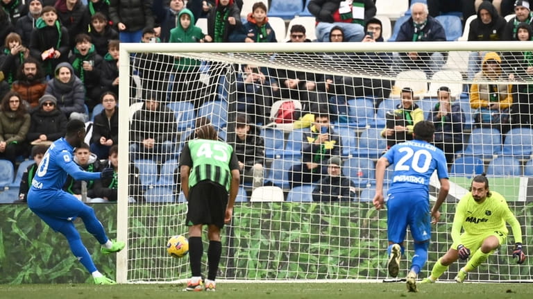 Empoli's M'Baye Niang, left, scores during the Serie A soccer...