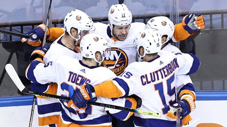 Matt Martin of the Islanders is congratulated by his teammates...