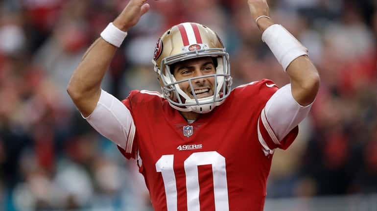 49ers quarterback Jimmy Garoppolo celebrates during the second half against...