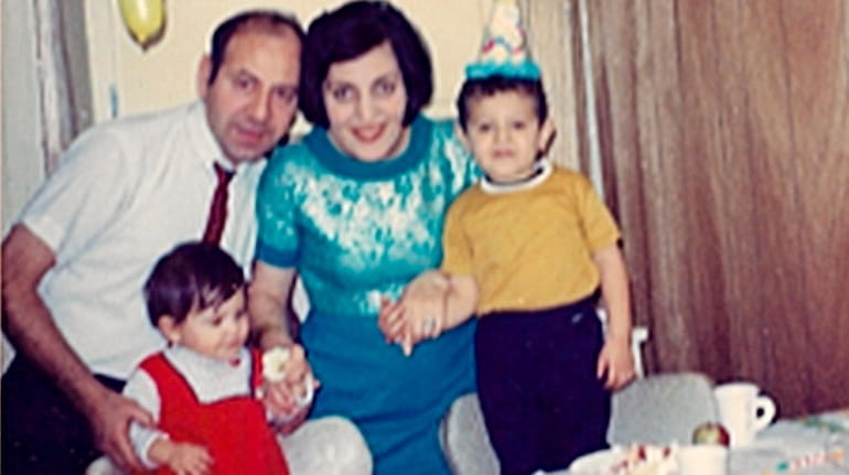 Mustafa and Guler Turhan with their children, Filiz, left, and...