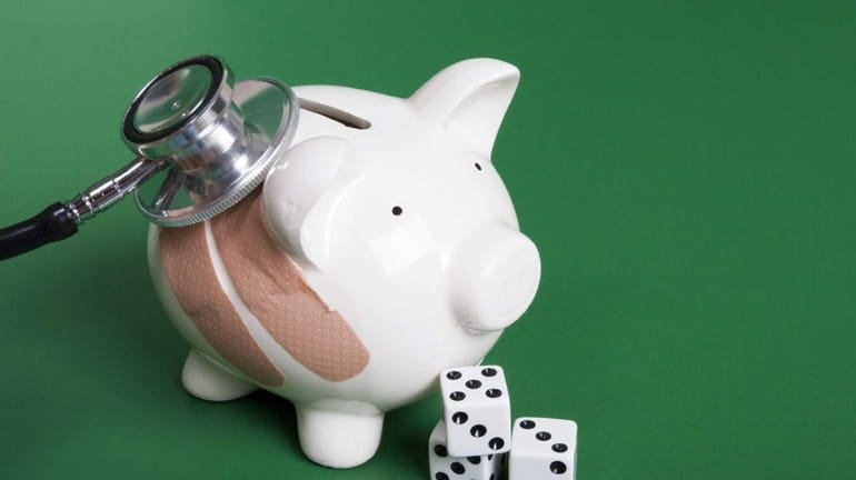 Piggy bank with dice and stethoscope