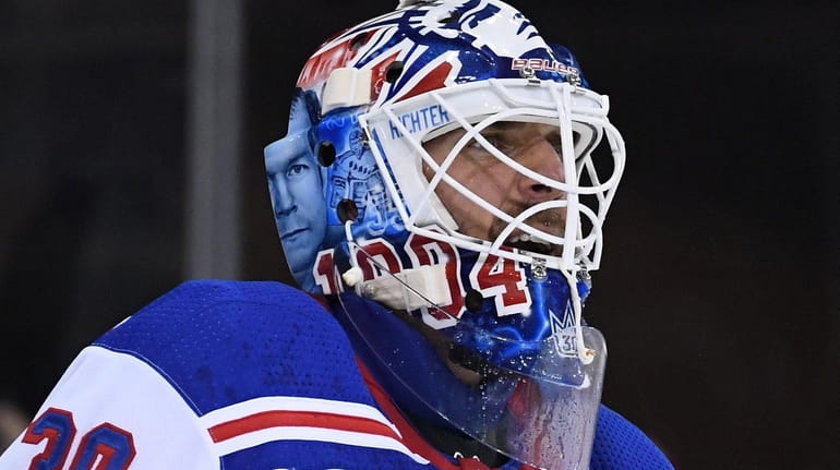Rangers goaltender Henrik Lundqvist wears a helmet with graphics honoring...