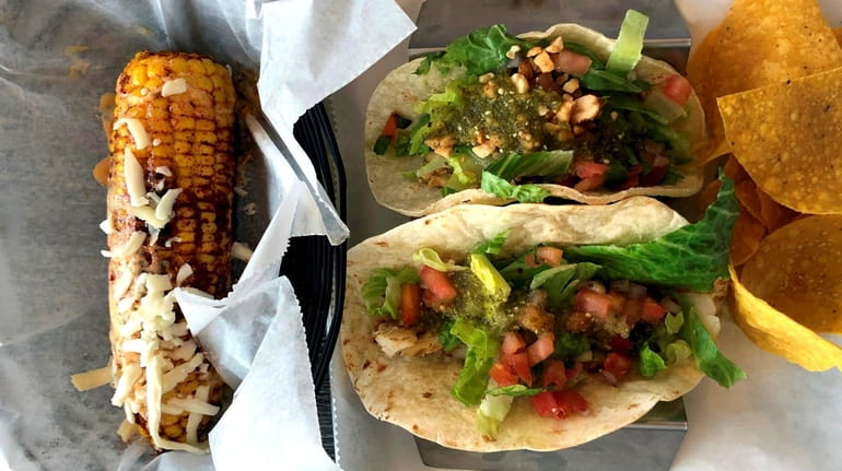 Tacos and street corn at High Tide Taco Bar, which...