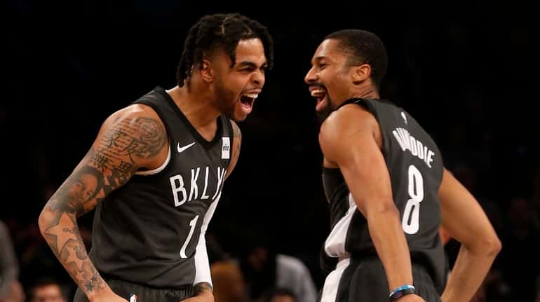D'Angelo Russell and Spencer Dinwiddie of the Nets react after...