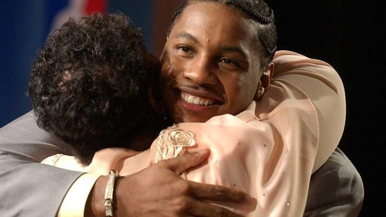 Carmelo Anthony, of Syracuse, gets a hug from his mother,...