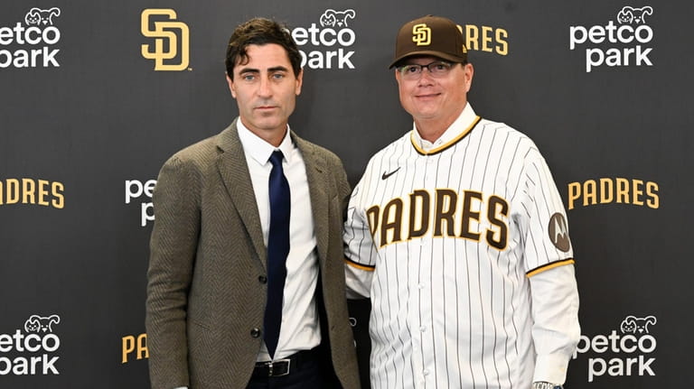 San Diego Padres general manager A.J. Preller, left, and San...